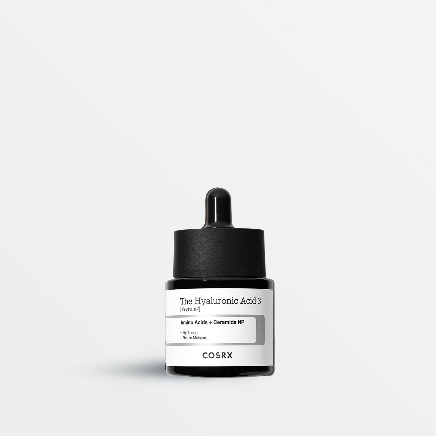 Cosrx skincare product with dropper on a light gray background