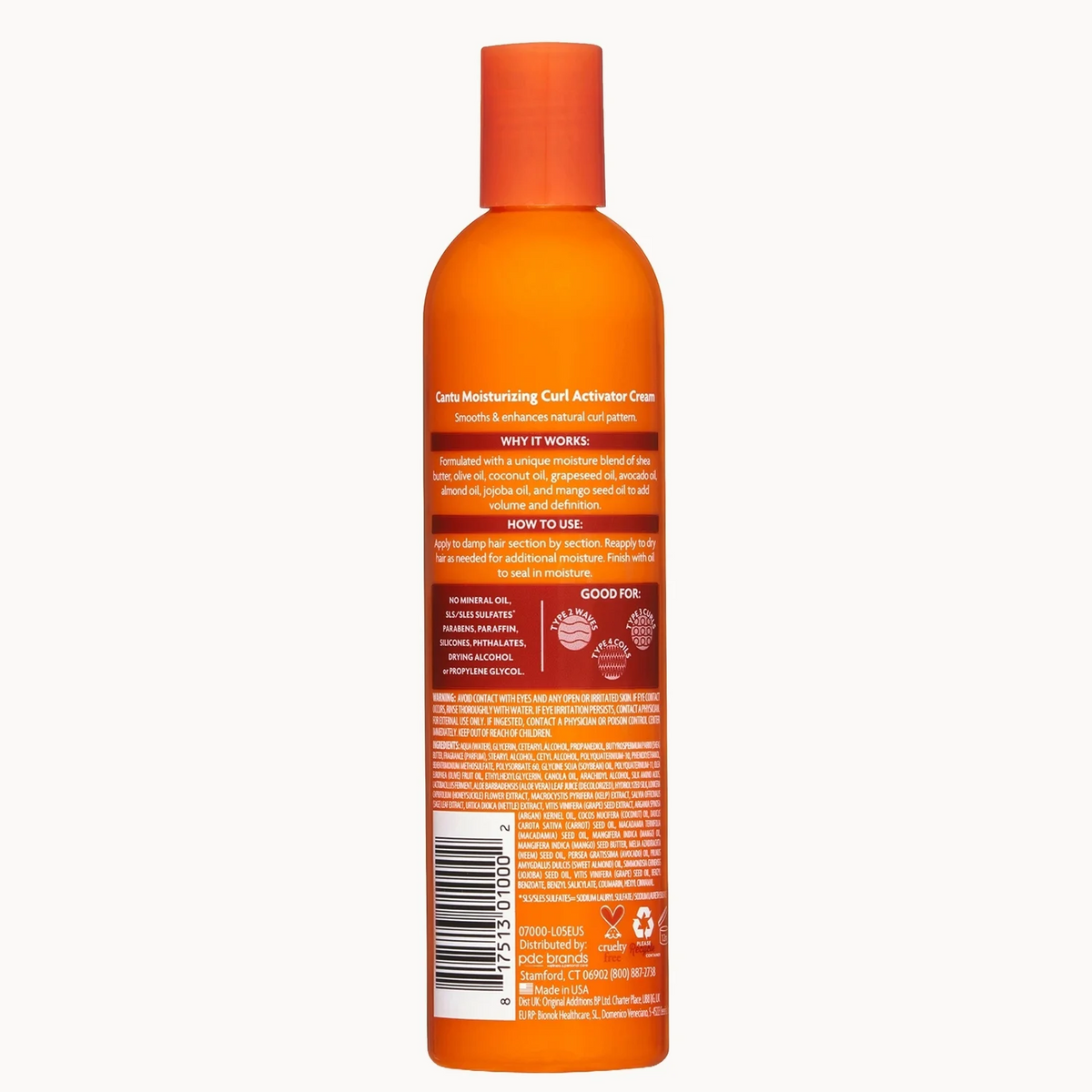 An orange bottle of hair care product shown from the back, featuring a matching orange cap and a detailed label with text and a barcode, set against a plain light gray background.