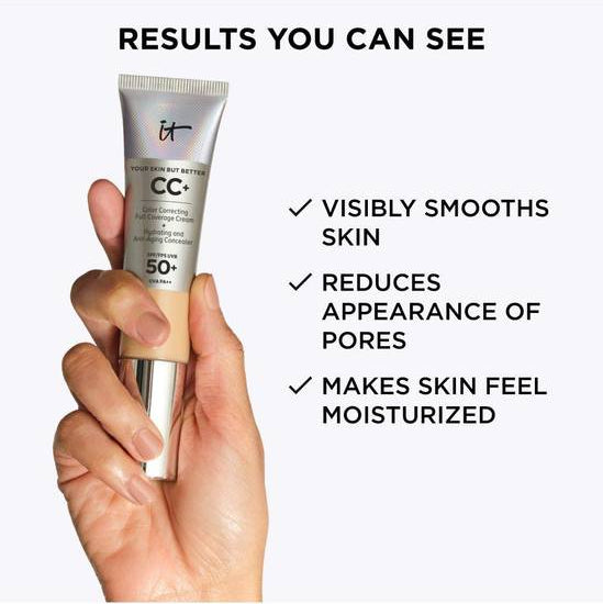 Hand holding a CC cream tube with text about product benefits on a white background