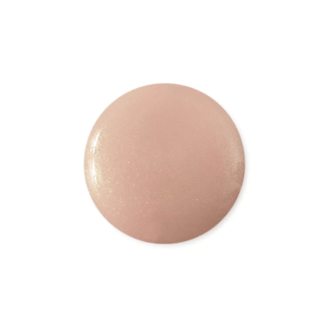 Round, pinkish-beige object on a white background