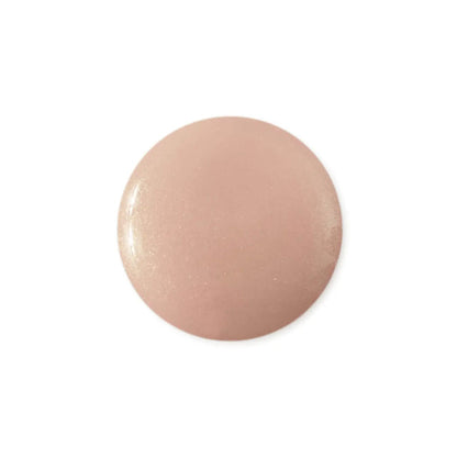 Round, pinkish-beige object on a white background