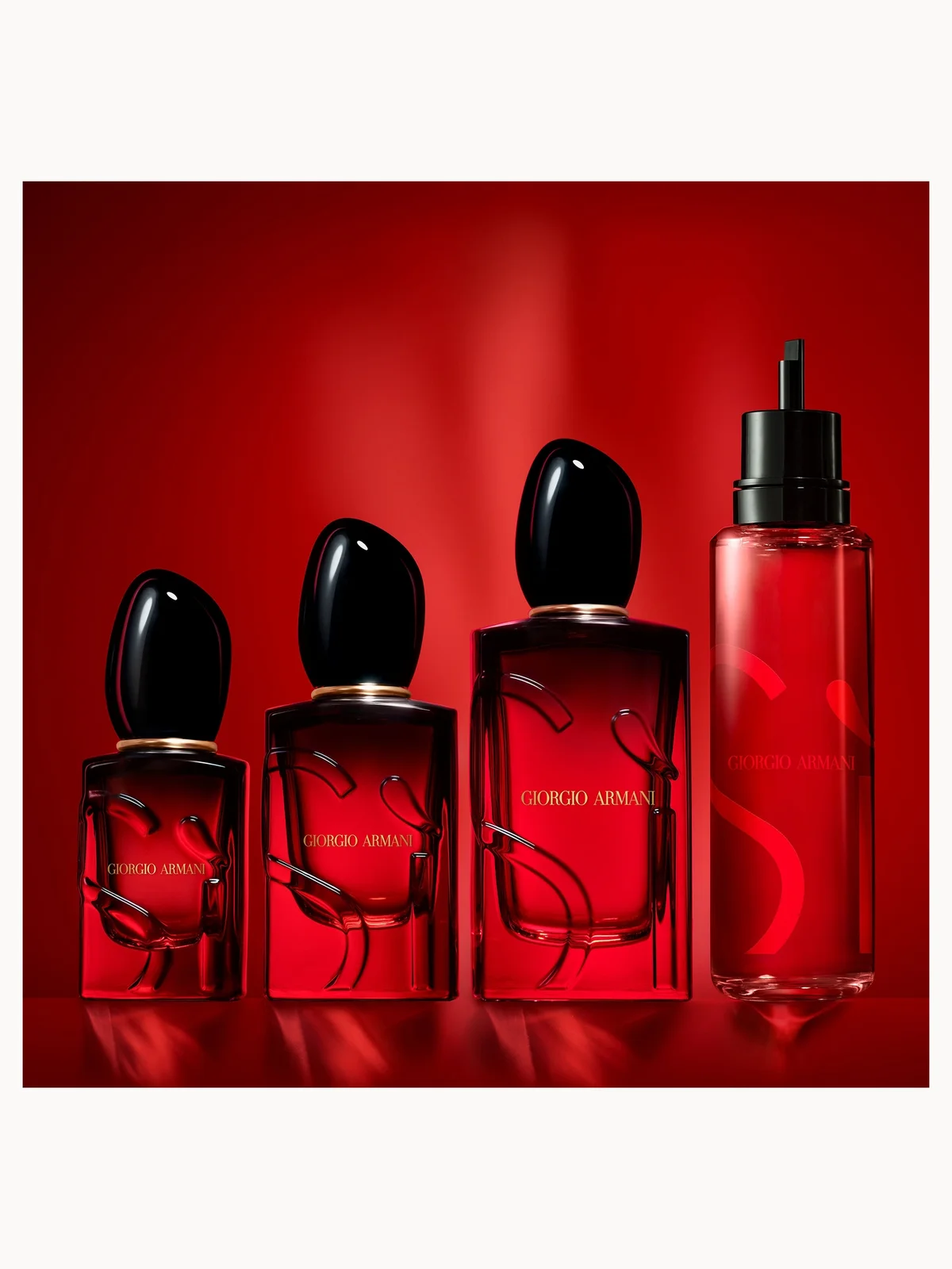 Set of Giorgio Armani perfume bottles on a red background