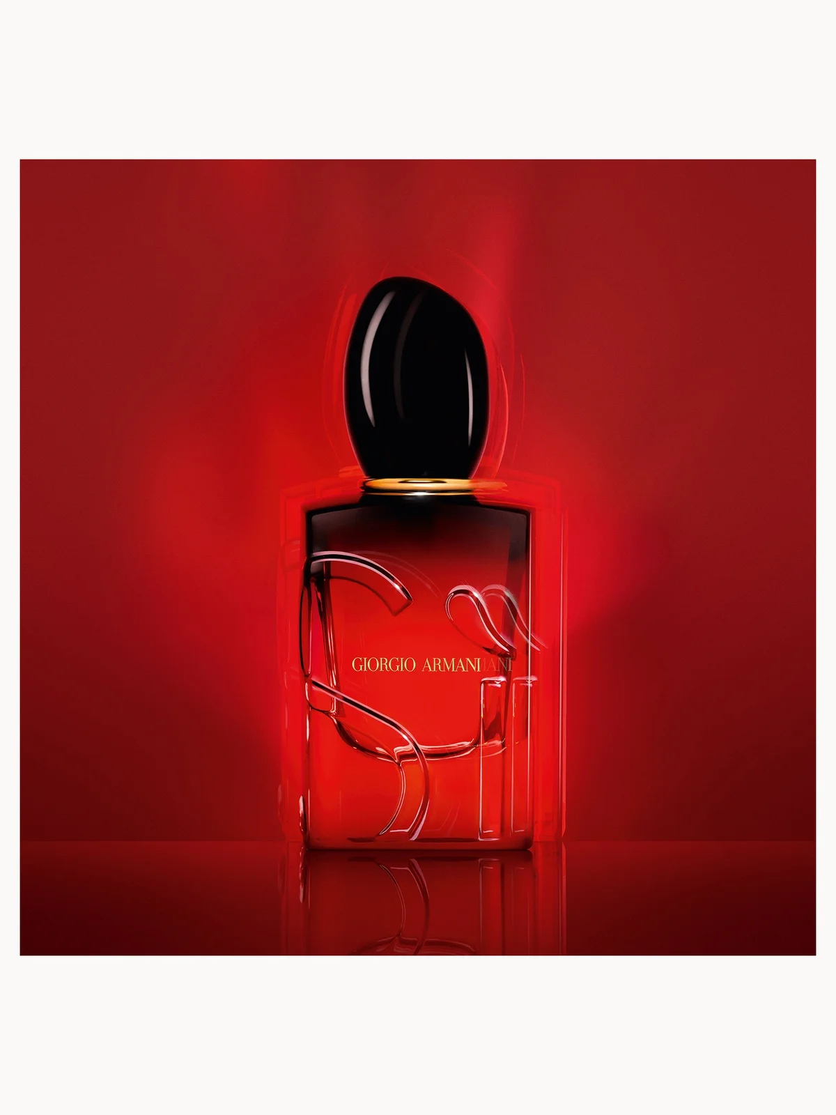 Armani Si Passione Intense Eau de Parfum bottle with black cap on a red background
