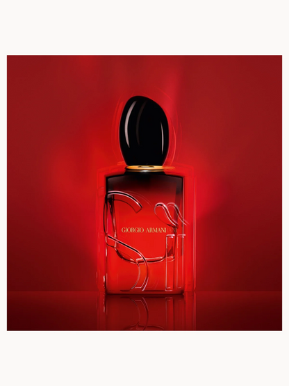 Armani Si Passione Intense Eau de Parfum bottle with black cap on a red background