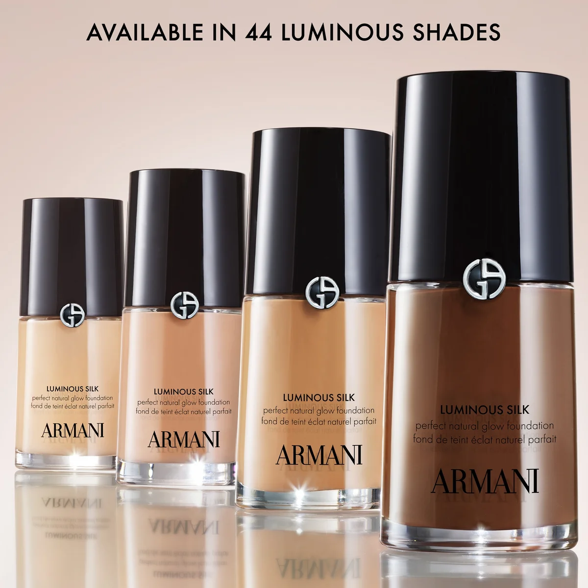 Armani foundation bottles in various shades on a beige background