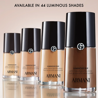 Armani foundation bottles in various shades on a beige background