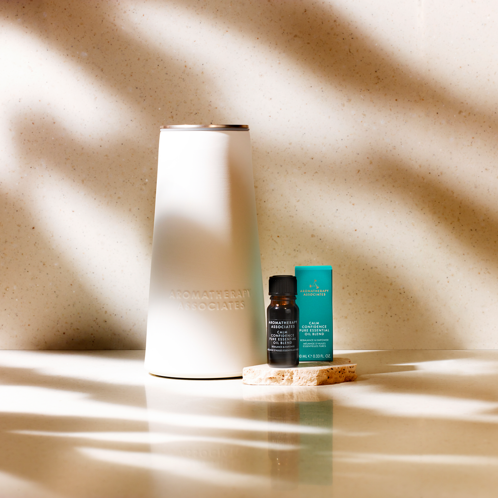 Three small bottles on a wooden surface with a textured beige wall background