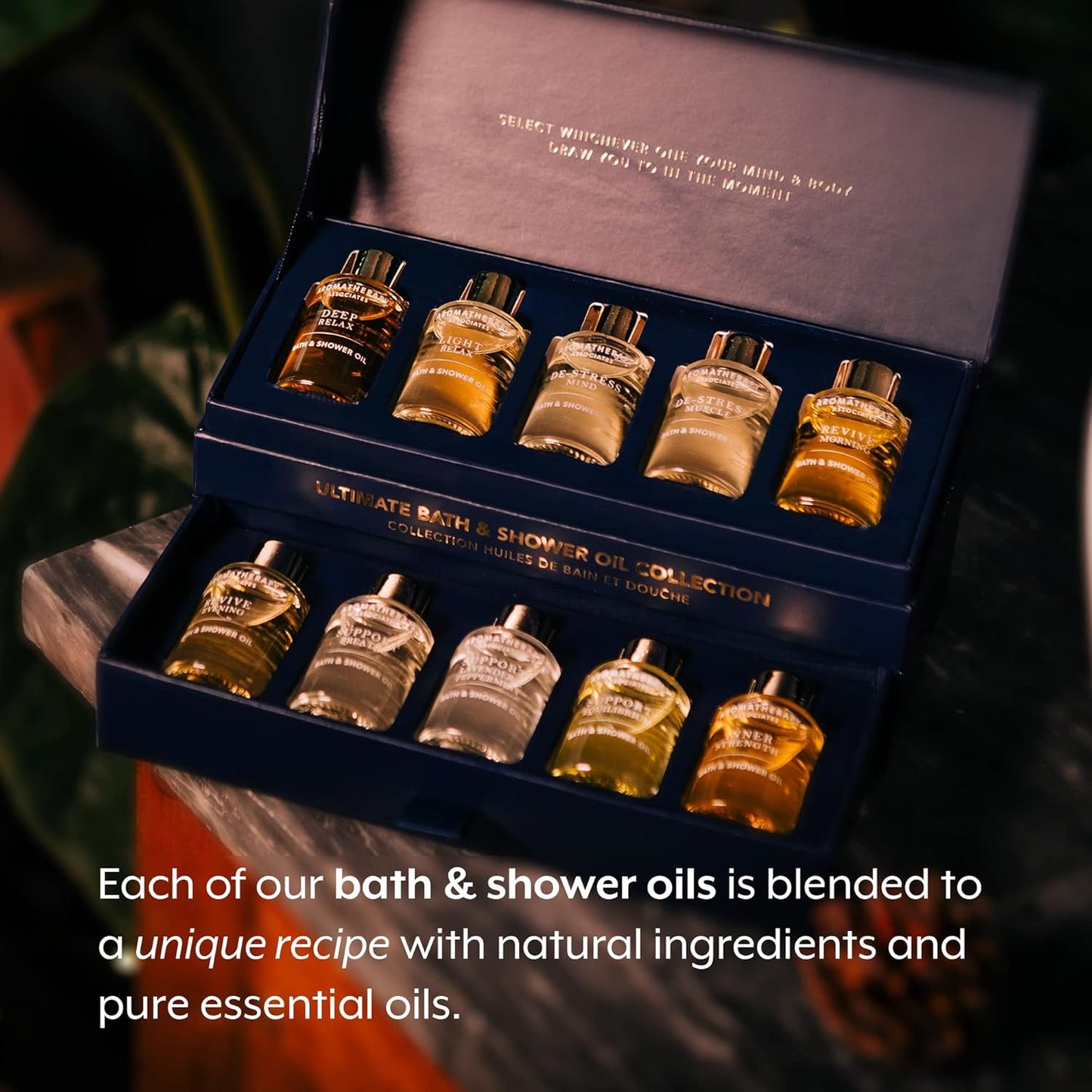 Collection of bath and shower oils in a box with text about unique recipes and natural ingredients.
