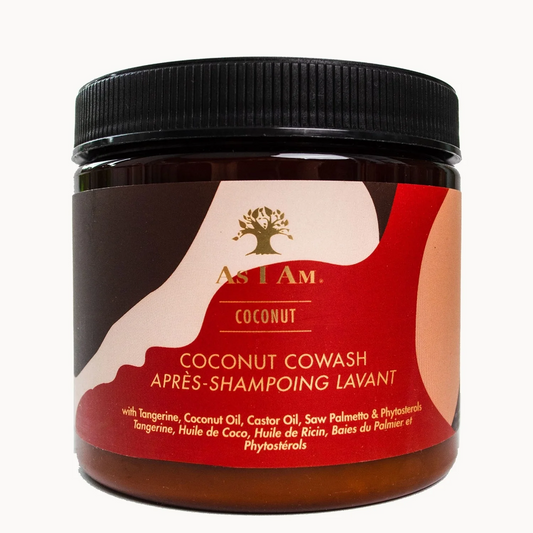 A jar of As I Am Coconut Cowash shampoo on a clean white background. The product is in a dark amber-brown jar with a black ribbed lid and a label featuring a brown, red, and beige cowhide pattern with gold branding.
