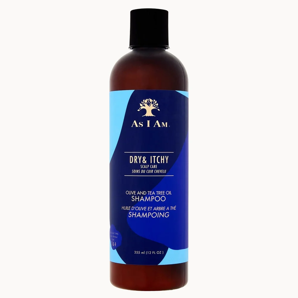 A 300 ml bottle of As I Am Dry & Itchy Oils and Tea Tree Oil Shampoo, featuring a dark amber-brown translucent bottle, a black cap, and a blue and light blue label with white text.