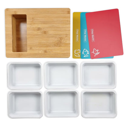 Set of wooden chopping board with a waste tray, silicone trays, and colorful plastic chopping boards on a white background