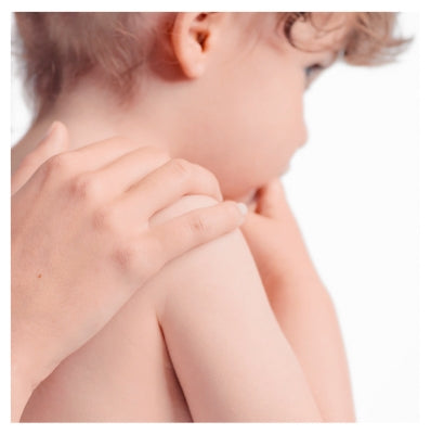 Close-up of a child's shoulder and neck with a blurred background