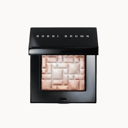 Bobbi Brown eyeshadow compact in a black square case, shown open with a single shimmering rectangular pan of warm champagne and rose gold shadow on a light gray background.