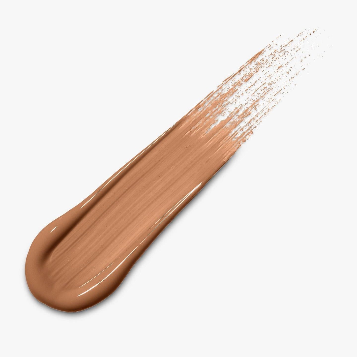 A diagonal smear of liquid foundation or concealer in a warm medium tan shade on a plain light gray background.