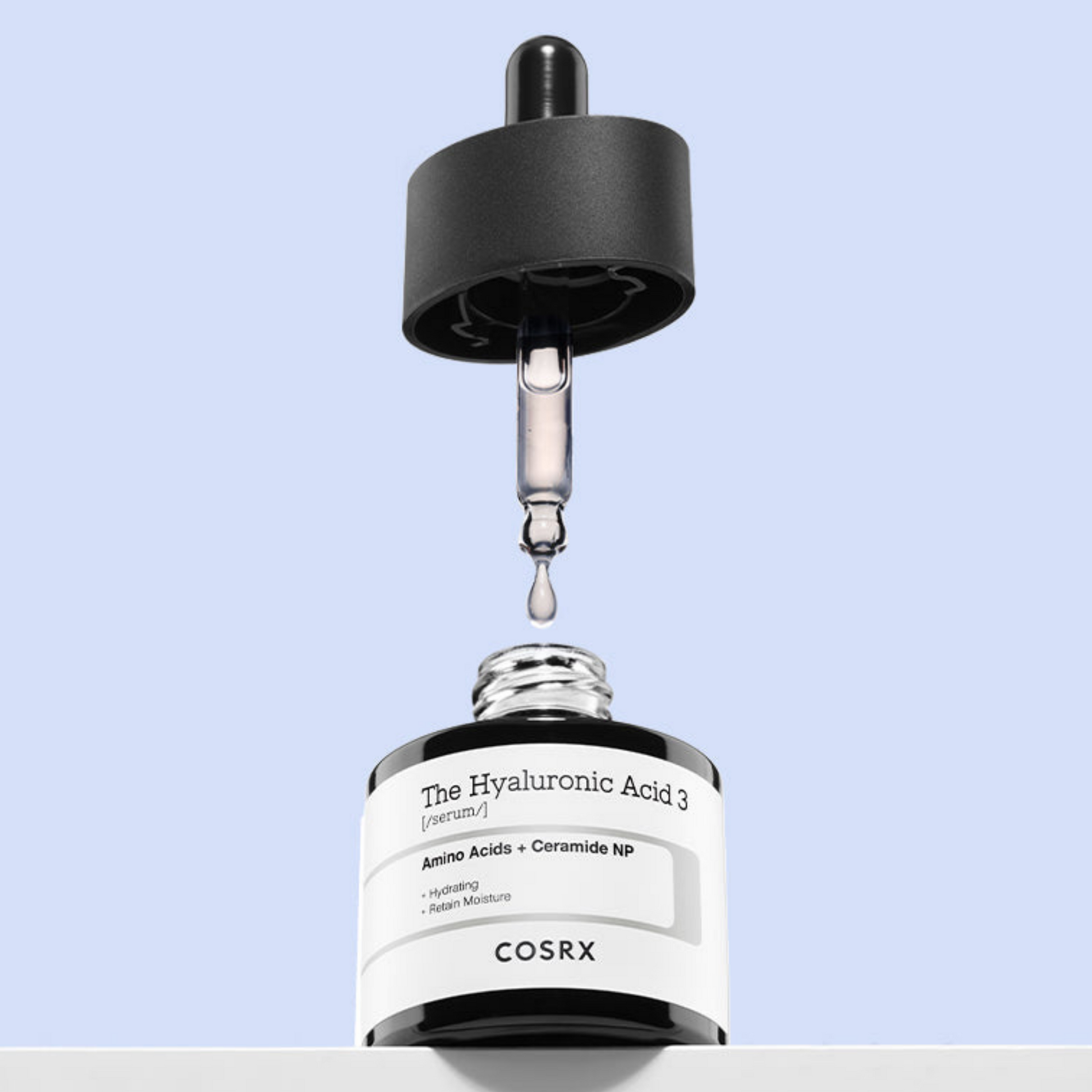 Cosrx skincare serum bottle with dropper on a light blue background