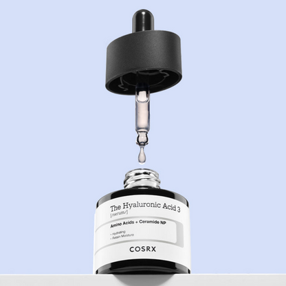 Cosrx skincare serum bottle with dropper on a light blue background