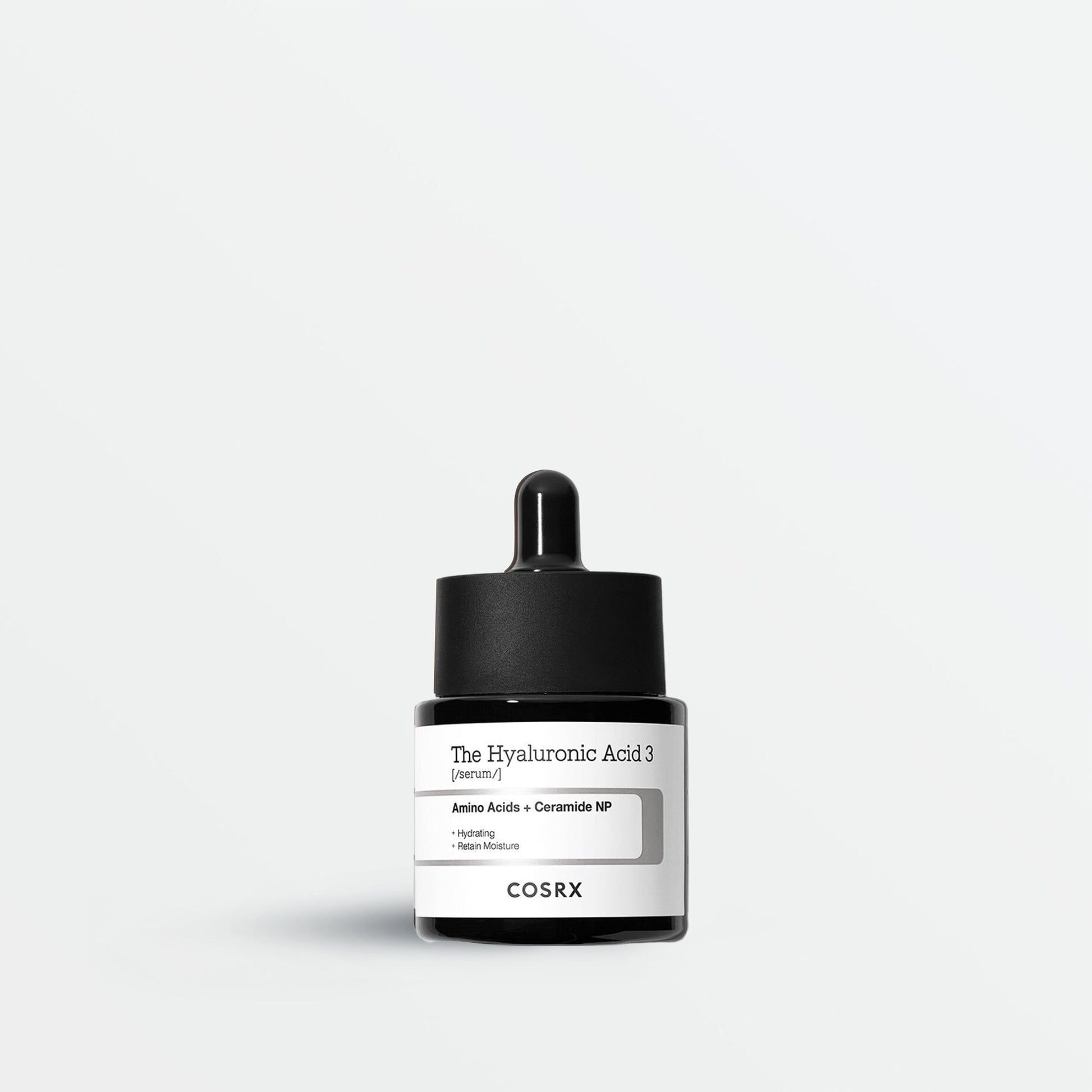 Cosrx skincare product with dropper on a light gray background