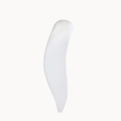 A single white cosmetic smear or swipe on a plain off-white background.