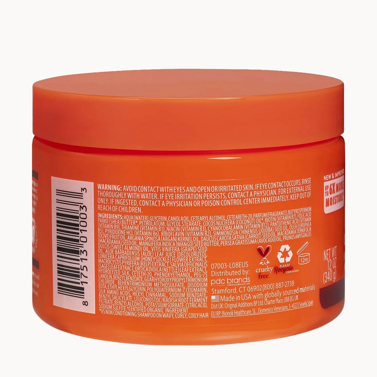 An orange plastic jar of hair product shown from the back, displaying the warning label, barcode, and ingredients text on a white background.