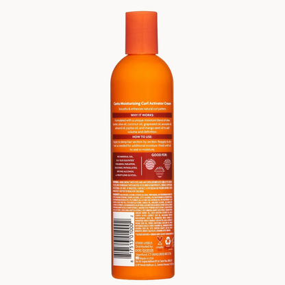 An orange bottle of hair care product shown from the back, featuring a matching orange cap and a detailed label with text and a barcode, set against a plain light gray background.