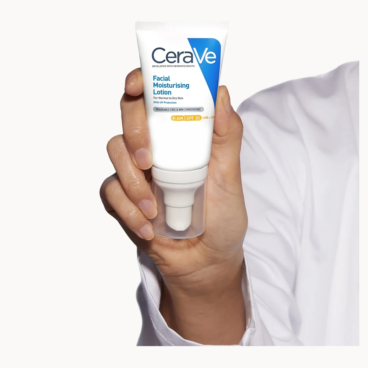 CeraVe facial moisturizing lotion held in a hand against a white background