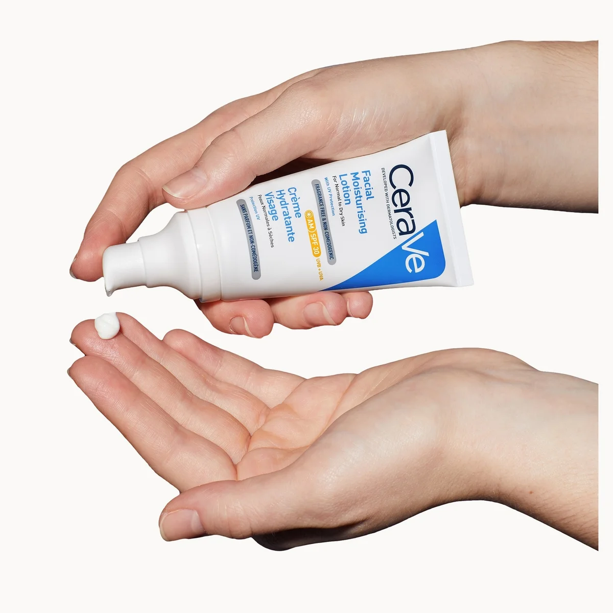 CeraVe tube being squeezed onto a palm against a white background