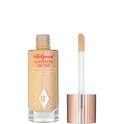Foundation bottle with applicator and 'Hollywood Flawless Filter' text on a white background