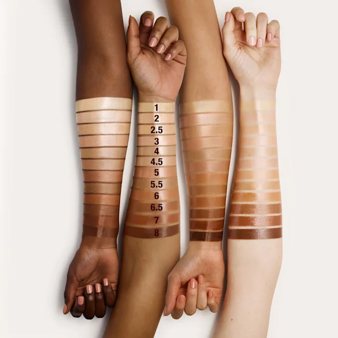 Four arms with different skin tones holding hands, displaying a color swatch chart.