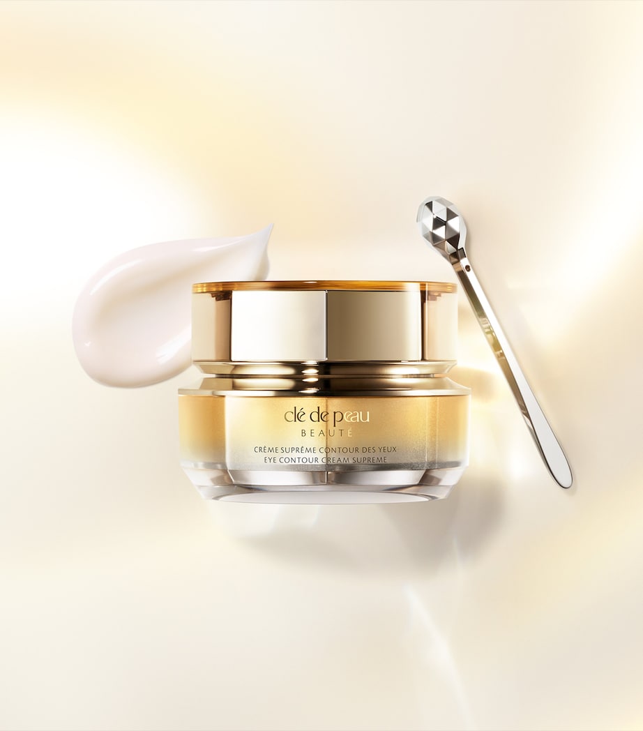 Cle de Peau eye cream jar with applicator on a soft beige background