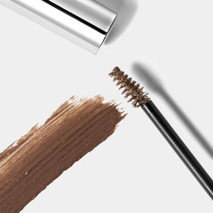 Eyebrow pencil with brown color swatch on a white background