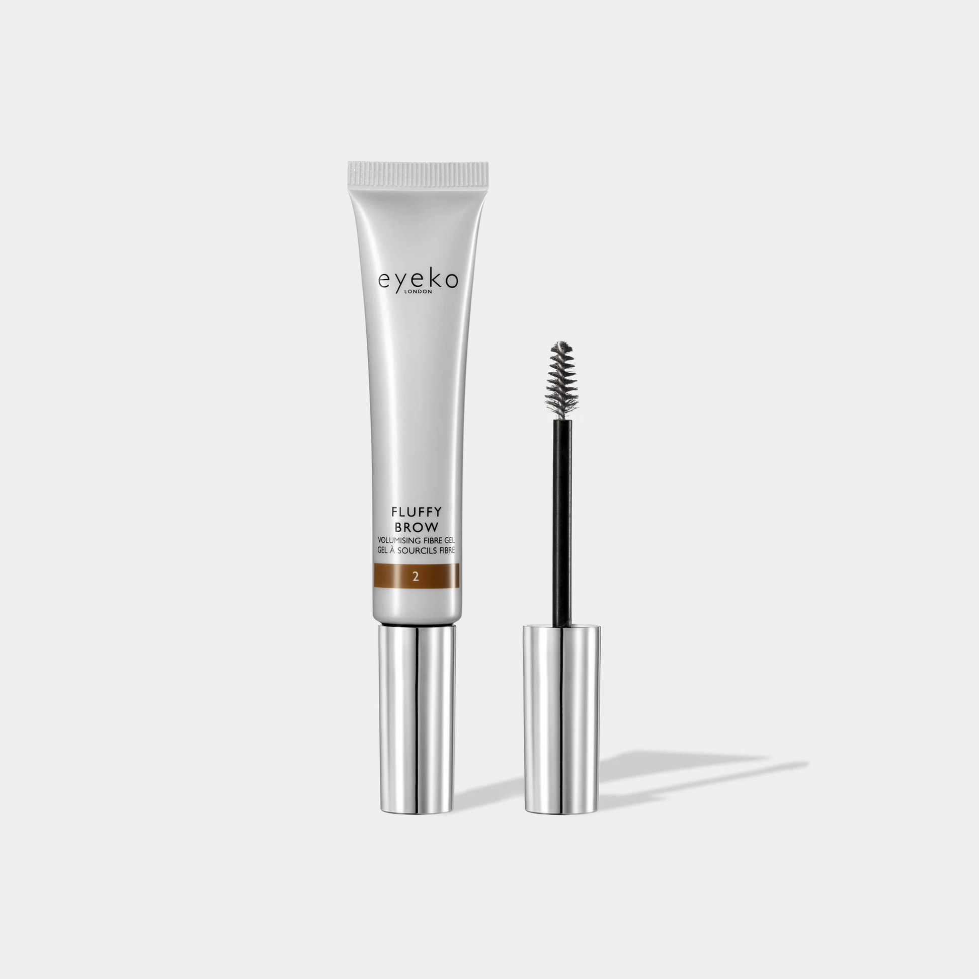 Eyeko Fluffy Brow product with applicator on a white background