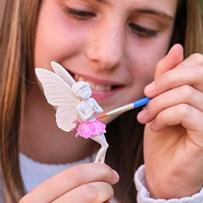 Girl painting a fairy figurine with a brush outdoors, 'Bryte' brand visible