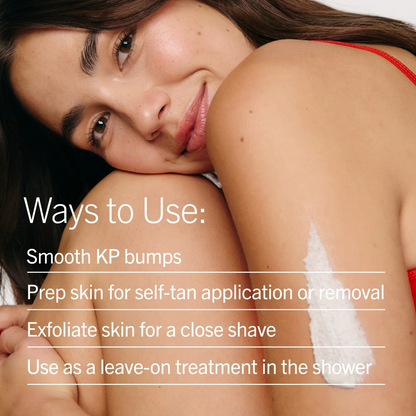 A close-up of a woman with white cosmetic cream applied to her shoulder, overlaid with the text 'Ways to Use: Smooth KP bumps, Prep skin for self-tan application or removal, Exfoliate skin for a close shave, Use as a leave-on treatment in the shower'.