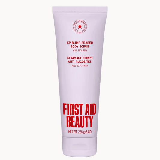 A tube of First Aid Beauty KP Bump Eraser Body Scrub on a clean white background. The tube is a very pale pinkish-white with red text and a red circular star logo.