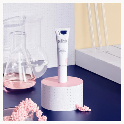 Skincare tube on a stand with pink beads and a blurred background