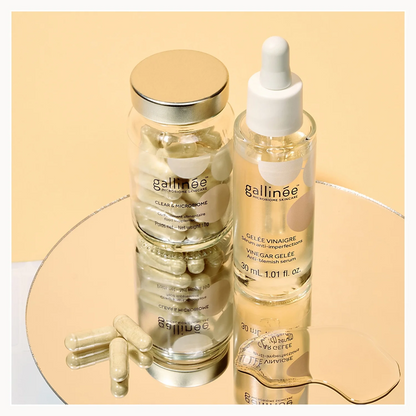 Two gallinee skincare products on a reflective surface with a beige background
