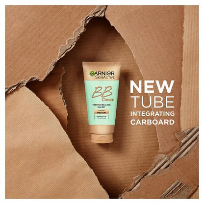 Garnier Skinactive BB Cream Perfecting Care All Over Face tube shown against a torn brown cardboard background with text reading 'NEW TUBE INTEGRATING CARBOHARD'.
