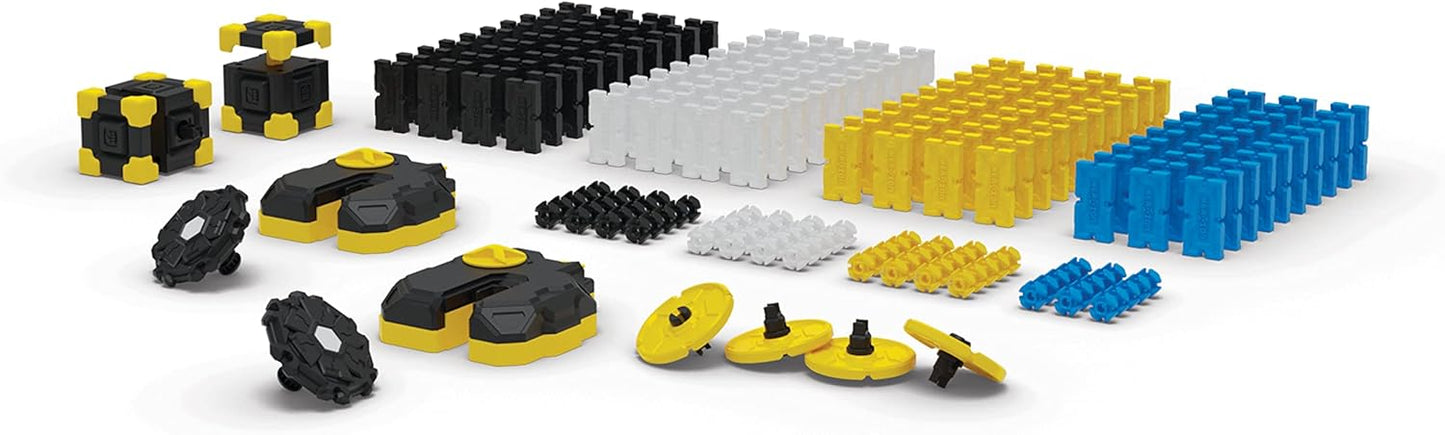 Assorted toy building block pieces in black, yellow, and blue on a white background