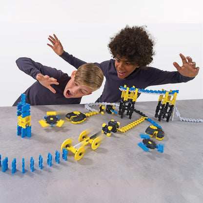 Two children playing with a stem toy construction blocks set on a gray surface.