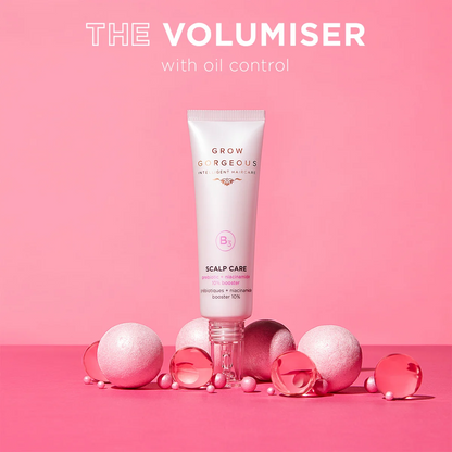 Tube of 'Grow Gorgeous' scalp care product with decorative items on a pink background