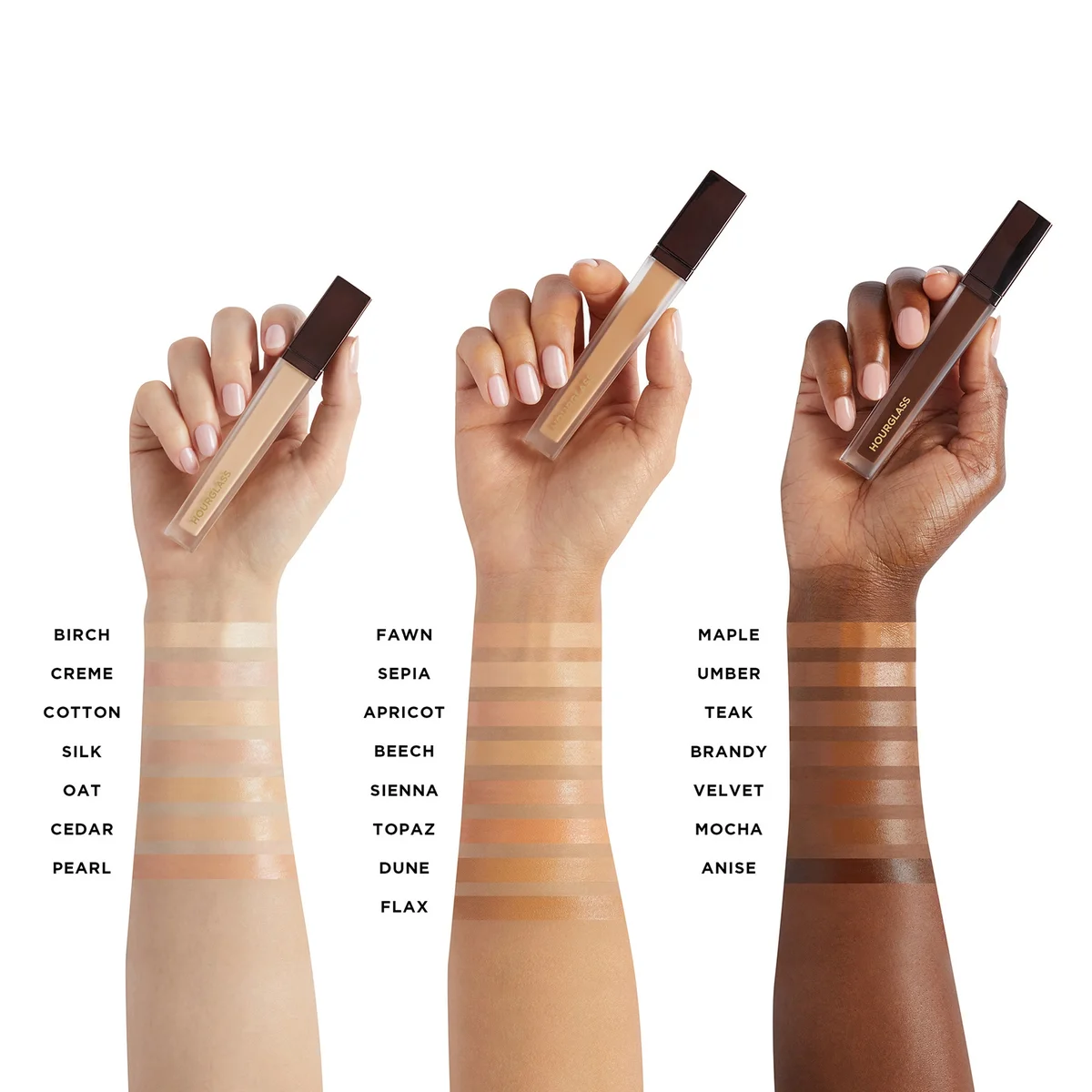 Three hands holding concealer tubes above swatches of the product on forearms, with shade names listed below: Birch, Creme, Cotton, Silk, Oat, Cedar, Pearl, Fawn, Apricot, Sienna, Topaz, Dune, Flax, Maple, Umer, Teak, Brandy, Velvet, Mocha, and Anise.