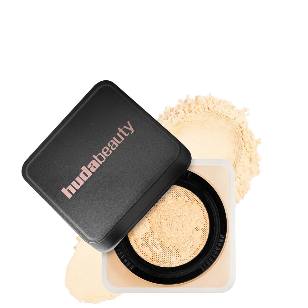 Huda Beauty compact powder with open lid on a white background