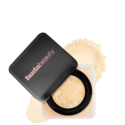 Huda Beauty compact powder with open lid on a white background