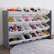 A gray and white rolling toy organizer with multiple plastic bins filled with colorful toys, shown in a room setting with a gray rug on the floor.