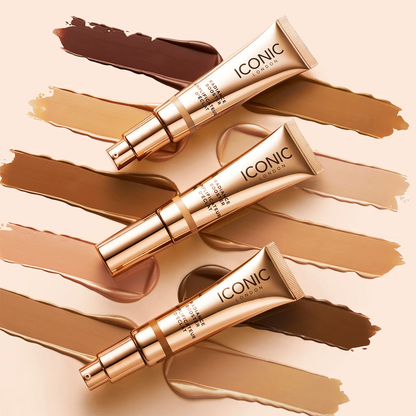 Three tubes of Iconic London foundation on a beige background with makeup swatches.