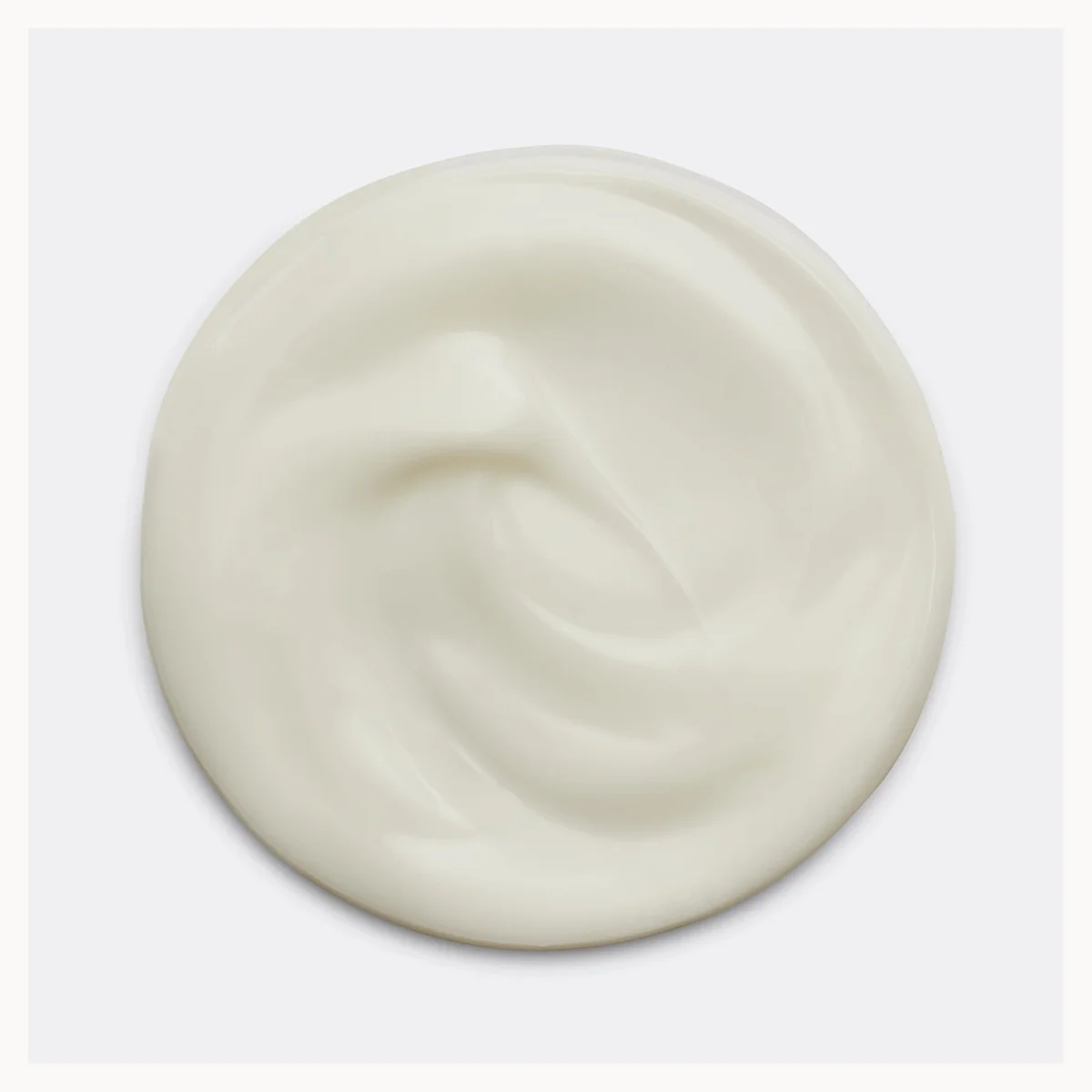 A swirl of thick, creamy off-white Joico hair conditioner shown from a top-down view on a light gray background.