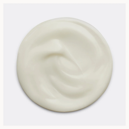 A swirl of thick, creamy off-white Joico hair conditioner shown from a top-down view on a light gray background.