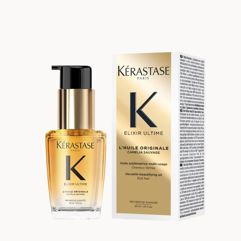 Kérastase Elixir Ultra hair oil bottle with a black pump and gold cap, shown next to its gold and white packaging box on a light gray background.