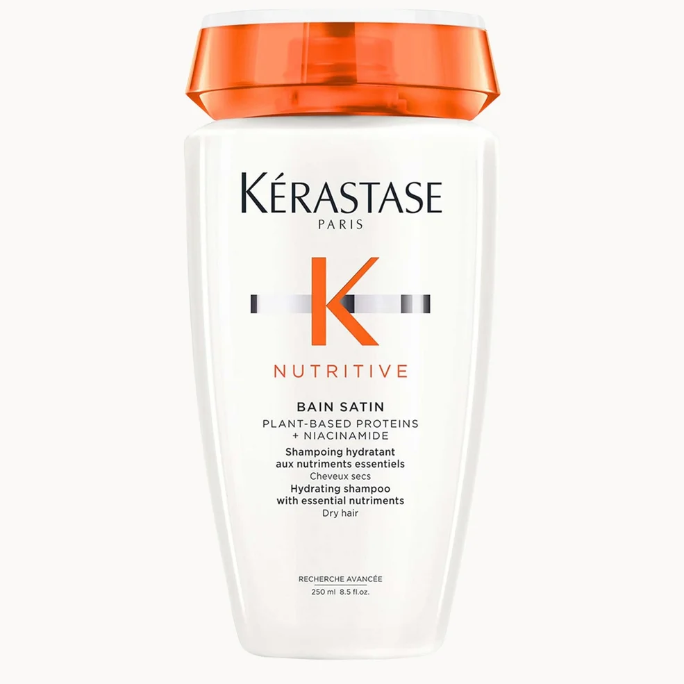 Kérastase Paris Bain Satin Nutritive plant-based protein and niacinamide shampoo bottle with an orange cap on a white background.