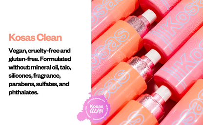 Close-up of several pink and orange cosmetic tubes arranged diagonally on a white background, with text on the left reading 'Kosas Clean' and a circular 'Kosas Clean' badge near the bottom.